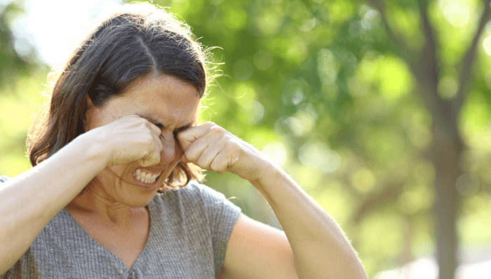 Woman itching her eyes